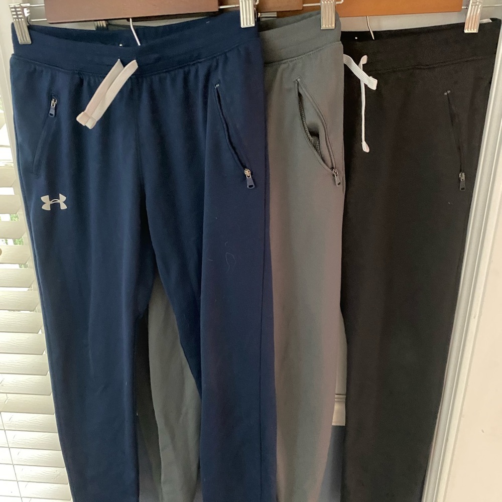 A bundle of three pairs of underarmour youth large pants.